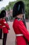 Amid tight security, Royal Guards in red and black uniform and bearskins line The Mall in London for Trooping the Colour Parade