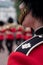 Amid tight security, Royal Guards in red and black uniform and bearskins line The Mall in London for Trooping the Colour Parade