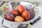 Amigo Pluot Fruits in a Stainless Steel Strainer with Knife