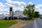 Amish Buggies Parked at White Barn