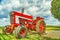 Amish country vintage red agricultural tractor with metal wheels on a field background in Lancaster, PA US