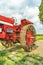 Amish country vintage red agricultural tractor with metal wheels on a field background in Lancaster, PA US