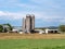 Amish farm complex with farmhouse, barns, silos, and surrounding farmlands