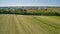 Amish Farm Harvesting his Crop using Horses and Antique Equipment as Seen by a Drone