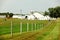 An Amish farm with pasture, barn silo and windmill.