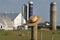 Amish farm with straw hat over fence post