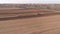 Amish Farm Worker Turning the Field in Early Spring as Seen by a Drone