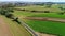 Amish farm workers organically fertilizing there fields as seen by a drone