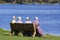 Amish girls sitting by the lake