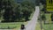 An amish horse and buggy riding along the road on the countryside