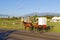 An Amish Horse and Carriage Travels on a Rural Road