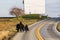 Amish people walking up rural road in Lancaster County PA
