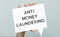 AML Anti-Money Laundering is written on paper