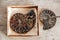 Ammonites fossil shell on wooden background. Top view. Copy, empty space for text. Polished half of petrified shells as souvenirs