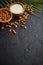 Amond seeds in wooden bowl, fresh natural milk placed on black stone background