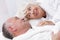 Amorous senior couple in bed