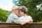 Amorous senior couple on a park bench