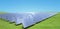 amount of solar panels on green field or solar farm againt blue sky