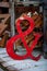 The ampersand symbol made of red metal