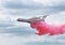 Amphibian aircraft B200 flies and demonstrates the discharge of water when extinguishing the fire