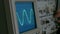 Amplitude Diagram on the oscilloscope. A man presses the buttons on the device. The geometric line changes shape