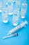 Ampoules with anesthetic on a blue background, syringe