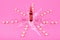 Ampoules with medicine and pills on pink background
