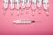 Ampoules on a pink background, syringe. Face aging, rejuvenation and hydration procedures. Aesthetic cosmetology