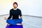 amputees handisport young man doing yoga meditation with closed eyes indoors at home