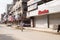 Amritsar, India - AUGUST 15: Bata Corporation multinational footwear and fashion accessory retail store. Man walking by dusty