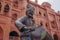 Amritsar, India - July 8, 2017: Statue of the drummer on the background of the red building. Amritsar, India