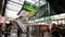 Amsterdam Airport Schiphol. Escalators. Airport terminal, shopping arcade with shops and people in transit