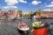 Amsterdam with basket of colorful tulips against canal in Holland