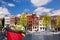 Amsterdam with basket of colorful tulips against canal in Holland