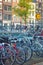 Amsterdam - bicycles in Europe..Ecological transport..Many bicycles are parked on the street and traditional old European houses.