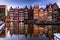 Amsterdam building\'s facade with reflection in canal, evening (long exposure shot)