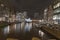 Amsterdam canal and buildings at night