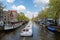 Amsterdam canal cruise ship with Netherlands traditional house i