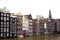 Amsterdam canal scene with old buildings and boat