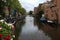 Amsterdam canal Singel with typical dutch houses and houseboats during morning blue hour, Holland, Netherlands. Used toning