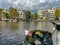 Amsterdam canal with typical dutch houses and houseboats, boats etc