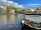 Amsterdam canal with typical dutch houses and houseboats, boats etc