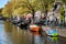 Amsterdam canal view with small boats. Spring day in the city