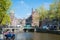 Amsterdam canals with bridges, boats and typical Dutch houses, Netherlands.