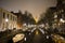 Amsterdam canals, night scene in old city with boats and lights reflected in water, Amsterdam, Netherland, March 24, 2019