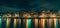 Amsterdam City panorama, illuminated buildings or dancing houses with reflection in water canal at night, Netherlands