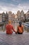 Amsterdam Damrak during sunset, happy couple man and woman on a summer evening at the canals