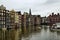 Amsterdam, Holland, August 2019. At the beginning of the Damrak, the typical Dutch houses overlook the water. The boats are moored