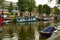 Amsterdam,Holland,August 2019. In the historic center a view that is a symbol of the city: a blue houseboat moored on the edge of