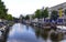 Amsterdam,Holland,August 2019. In the historic center a view that is a symbol of the city: a brown houseboat moored on the edge of